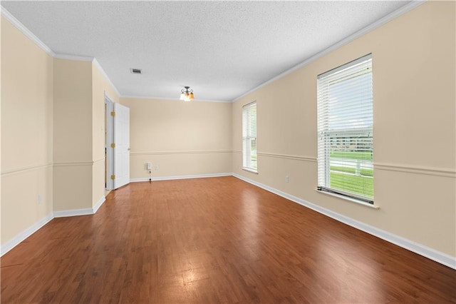 unfurnished room with ornamental molding, a healthy amount of sunlight, and hardwood / wood-style floors