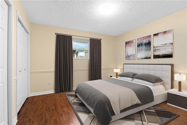 bedroom featuring a textured ceiling and hardwood / wood-style floors