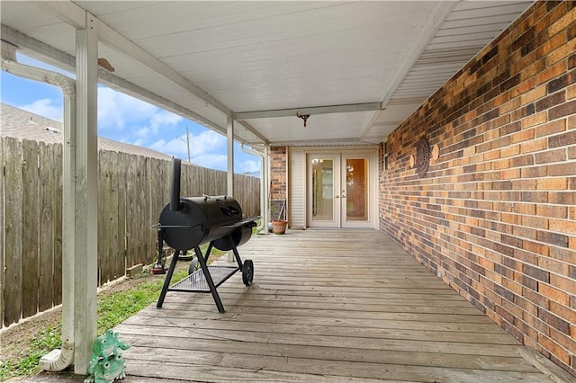 wooden deck featuring french doors and a grill