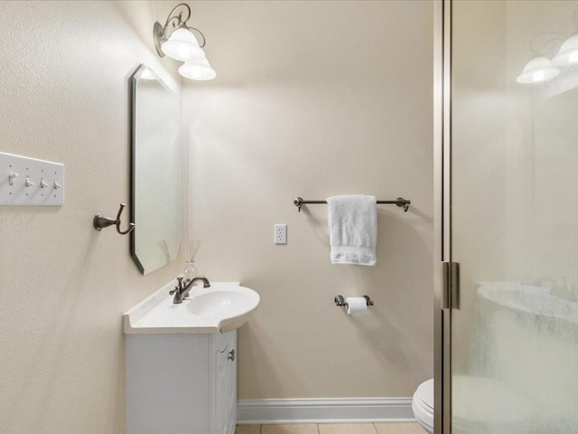 bathroom with vanity, tile patterned flooring, a shower with shower door, and toilet