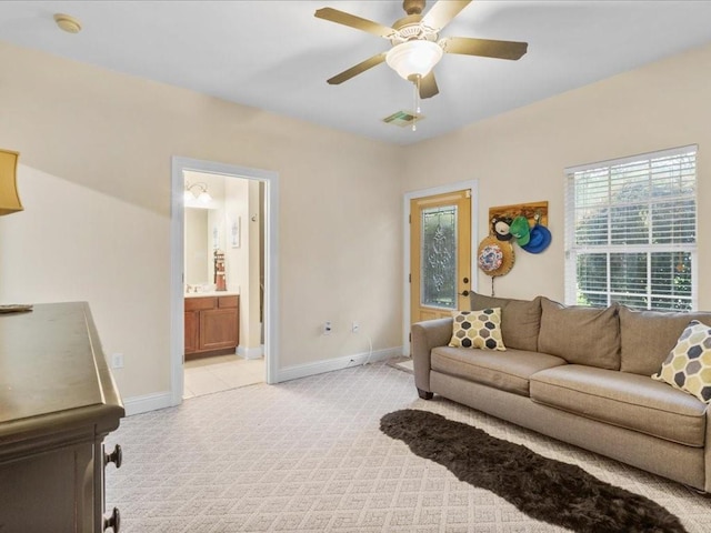 carpeted living room featuring ceiling fan