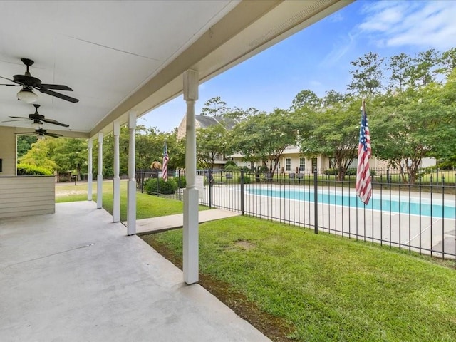 view of patio with a fenced in pool and ceiling fan