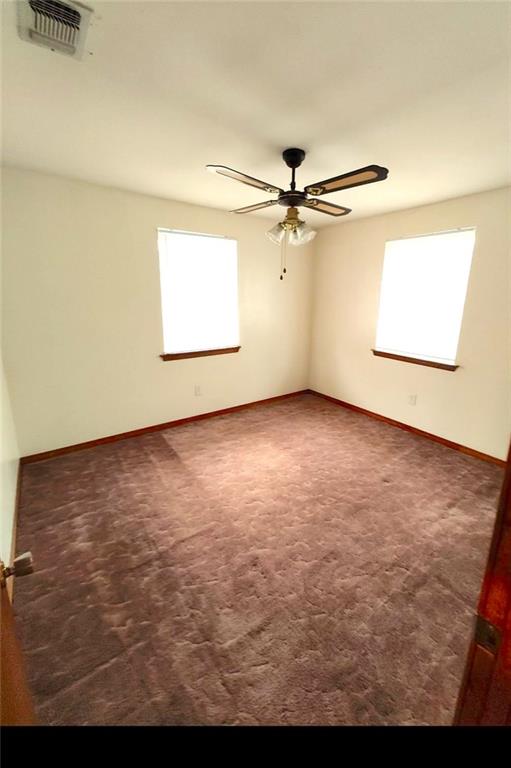 spare room with carpet flooring and ceiling fan