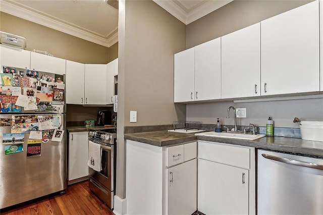 kitchen with sink, white cabinets, appliances with stainless steel finishes, and crown molding