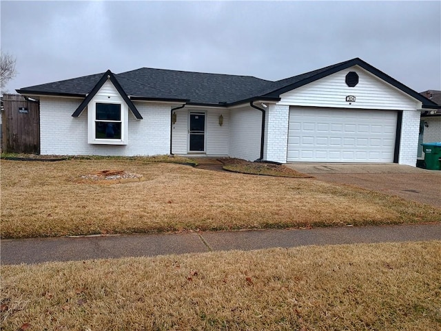 ranch-style home with a garage and a front lawn