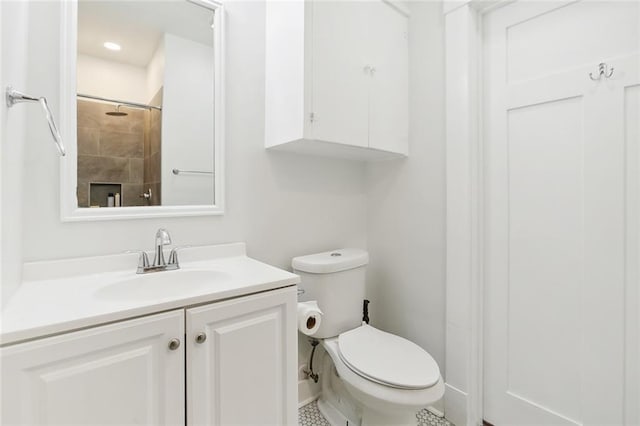 bathroom with vanity, tile patterned flooring, and toilet