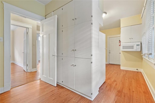 hallway with light wood-type flooring