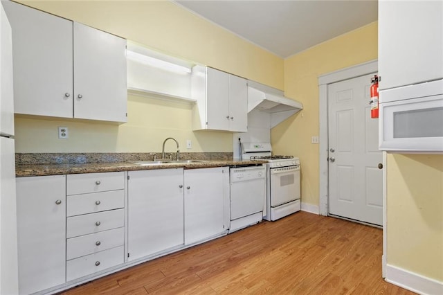 kitchen featuring range, white cabinets, white dishwasher, light hardwood / wood-style floors, and sink