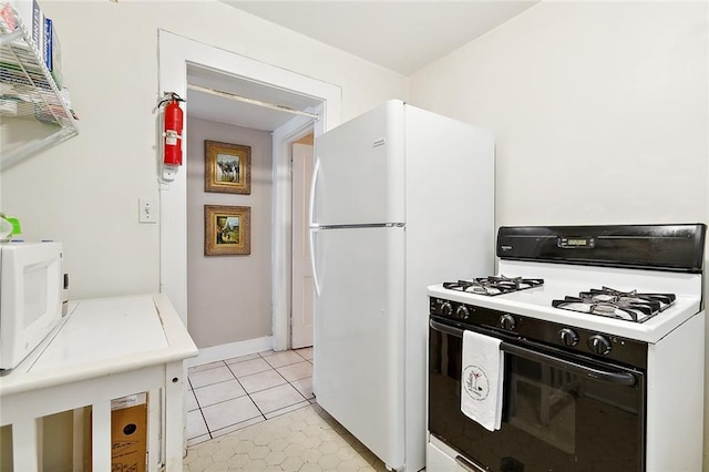 kitchen featuring white appliances and light tile patterned floors