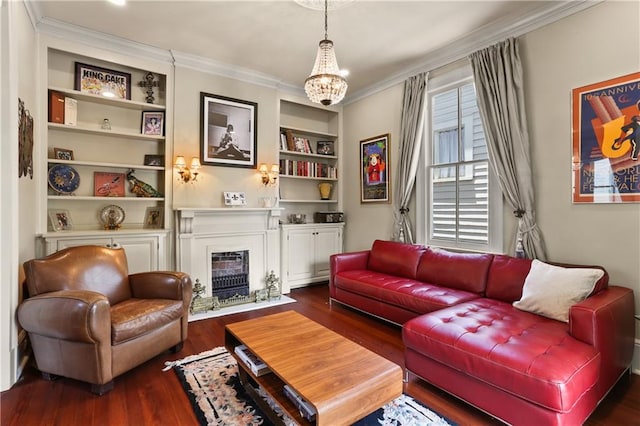 living room featuring crown molding, a chandelier, built in shelves, and dark hardwood / wood-style flooring