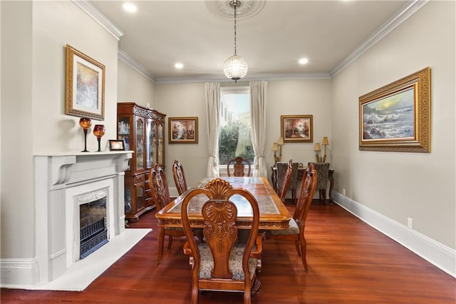 dining area with a fireplace, hardwood / wood-style flooring, and ornamental molding