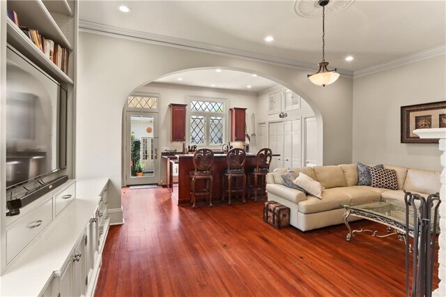 living room featuring ornamental molding and dark hardwood / wood-style flooring