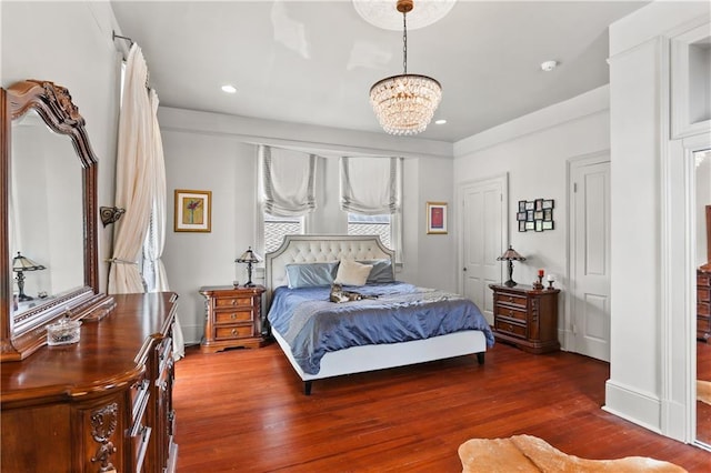 bedroom featuring hardwood / wood-style floors and a chandelier