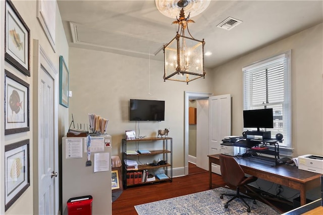 home office featuring dark hardwood / wood-style flooring and a notable chandelier