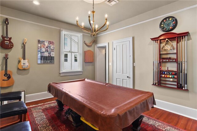 recreation room with hardwood / wood-style floors, billiards, and an inviting chandelier