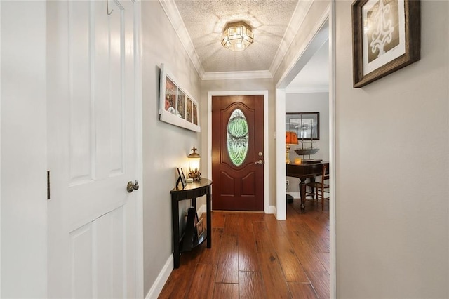 foyer entrance featuring a textured ceiling, ornamental molding, and dark hardwood / wood-style flooring