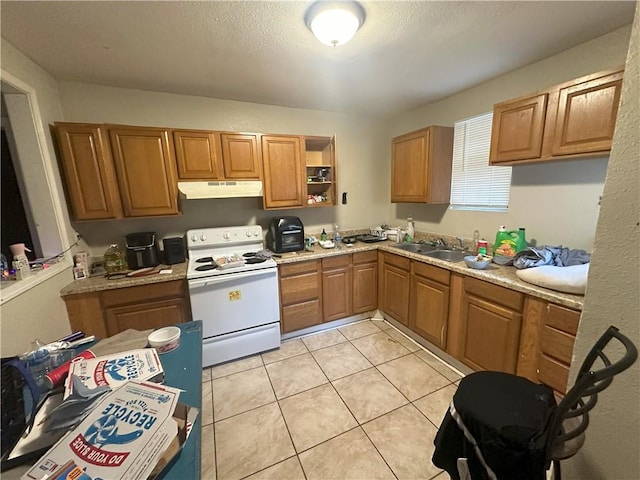 kitchen featuring light tile patterned floors, sink, and electric stove