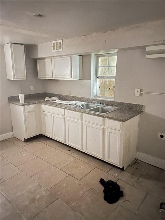 kitchen featuring white cabinets and sink