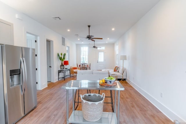 living room with ceiling fan and light hardwood / wood-style floors