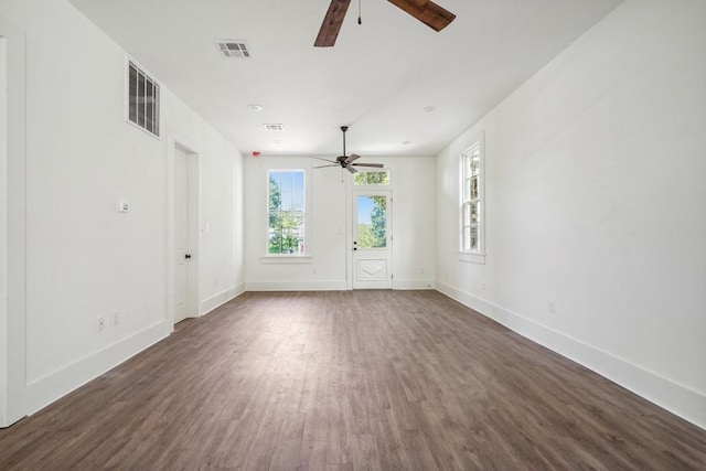 empty room with ceiling fan and dark hardwood / wood-style floors