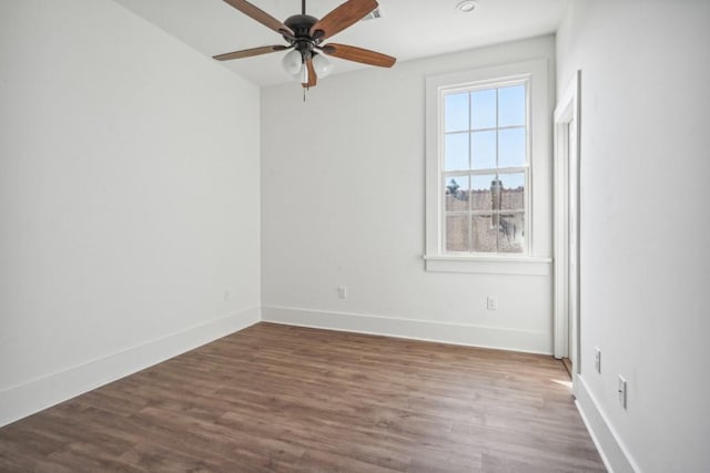 empty room featuring ceiling fan and dark hardwood / wood-style flooring