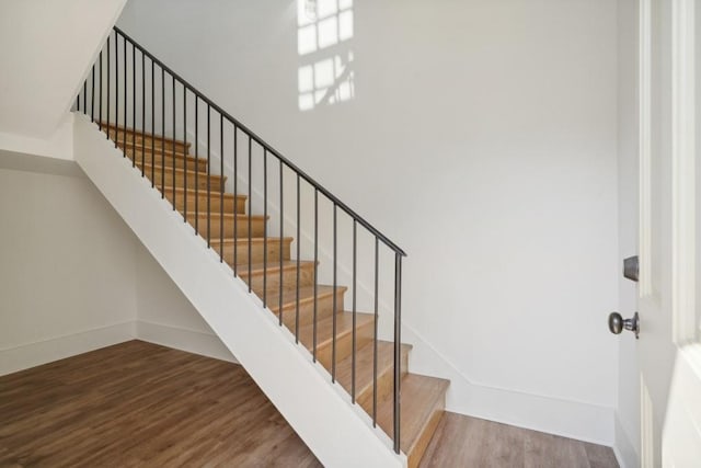 staircase with hardwood / wood-style flooring