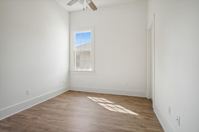 unfurnished room with ceiling fan and hardwood / wood-style floors