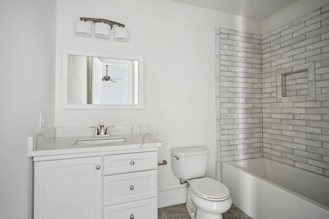 bathroom featuring ceiling fan, vanity, toilet, and tile patterned floors