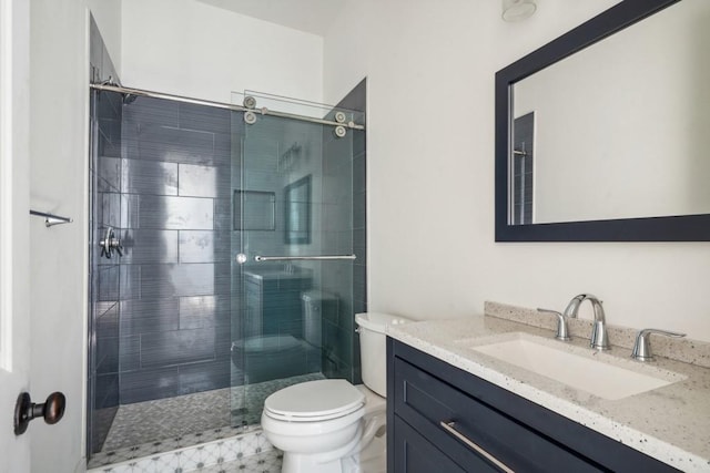 bathroom with walk in shower, vanity, and toilet