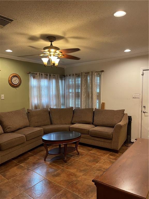 living room with ceiling fan, crown molding, and a textured ceiling