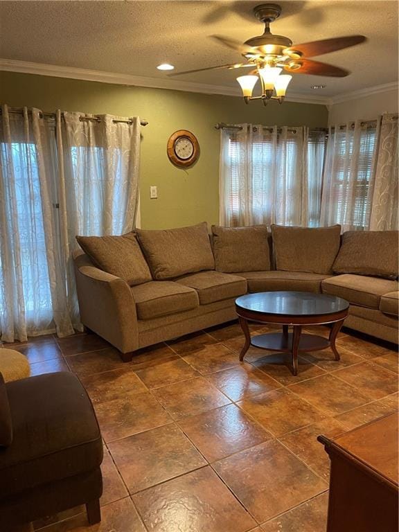 living room featuring crown molding, ceiling fan, and a textured ceiling