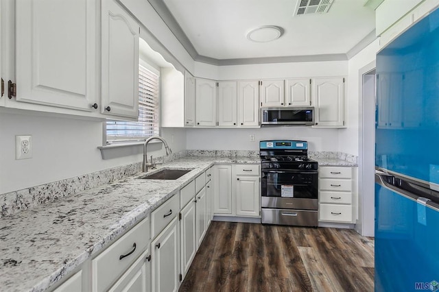 kitchen featuring white cabinetry, sink, light stone counters, dark hardwood / wood-style floors, and appliances with stainless steel finishes