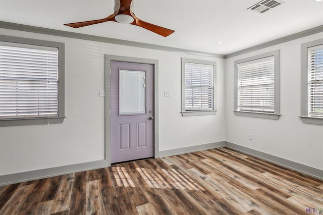 entrance foyer featuring ornamental molding, hardwood / wood-style floors, and ceiling fan