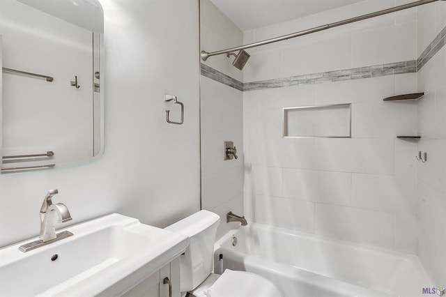 full bathroom featuring vanity, toilet, and tiled shower / bath