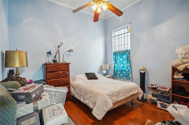 bedroom featuring ceiling fan, crown molding, and hardwood / wood-style floors