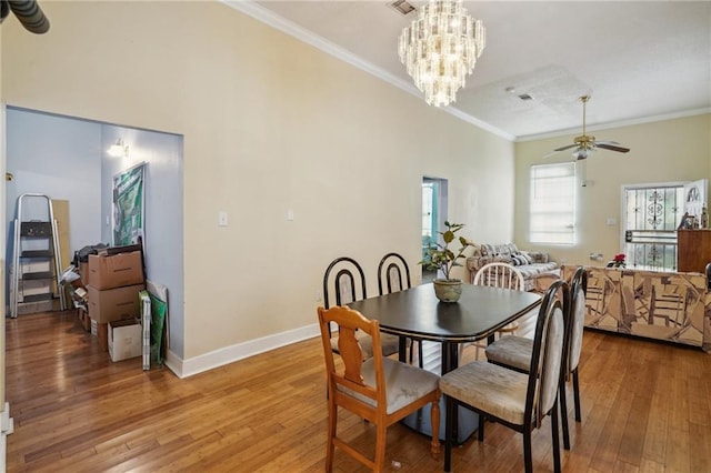 dining room featuring ceiling fan with notable chandelier, ornamental molding, and hardwood / wood-style floors