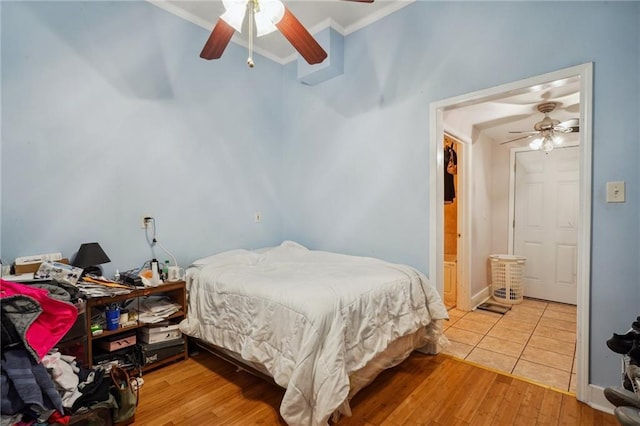 bedroom featuring ornamental molding, ceiling fan, and hardwood / wood-style flooring