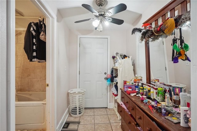 mudroom with ceiling fan and light tile patterned floors