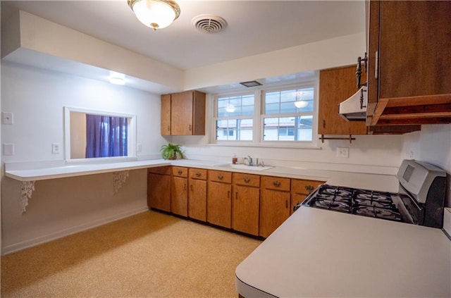 kitchen featuring light colored carpet, white range with gas stovetop, sink, and extractor fan