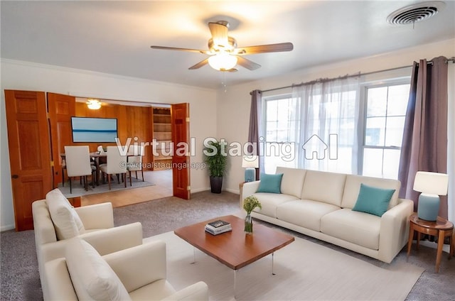 carpeted living room with ceiling fan