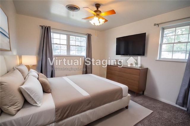 bedroom with multiple windows, carpet, and ceiling fan