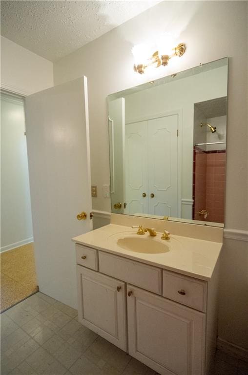 bathroom with a textured ceiling and vanity