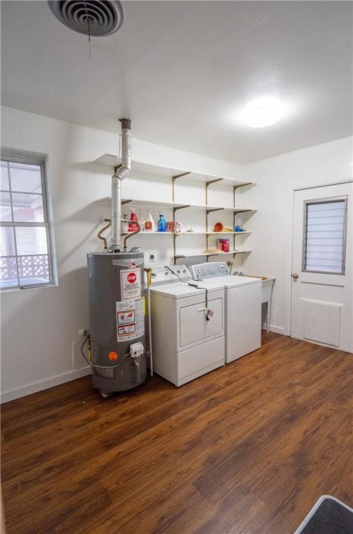 washroom with ceiling fan, gas water heater, dark hardwood / wood-style floors, and washing machine and clothes dryer