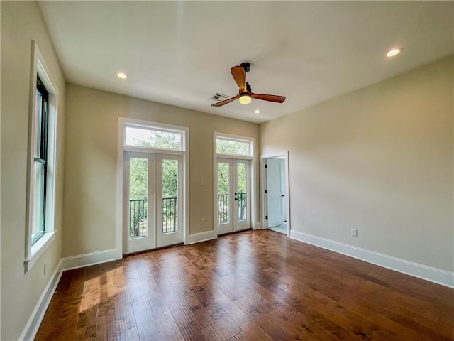 unfurnished room featuring recessed lighting, visible vents, dark wood-type flooring, and french doors