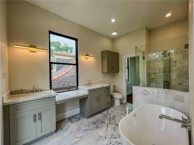 bathroom with a soaking tub, marble finish floor, vanity, a shower stall, and recessed lighting