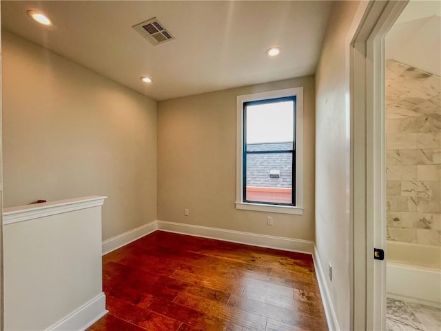 unfurnished room featuring hardwood / wood-style flooring