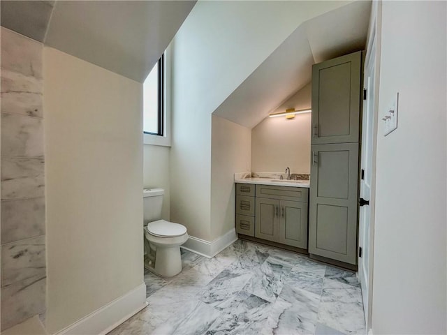 bathroom with vanity, toilet, tile patterned flooring, and vaulted ceiling