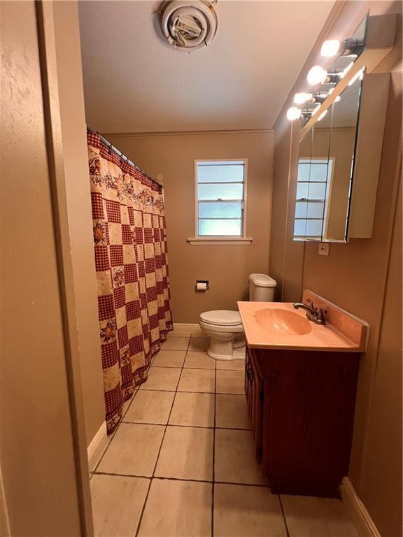 bathroom with vanity, toilet, and tile patterned flooring