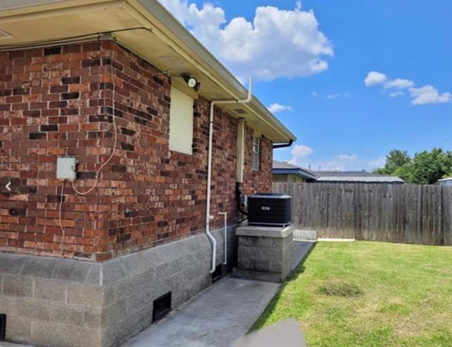 view of home's exterior featuring central AC and a lawn