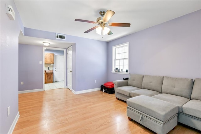 living room with ceiling fan and light hardwood / wood-style floors